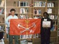 Alexander E. Andreyev, Russian Group Leader, and Gloria Coulter, Principal of Muriel S. Snowden International School at Copley, holding the flag of the City of Saint Petersburg, Russia